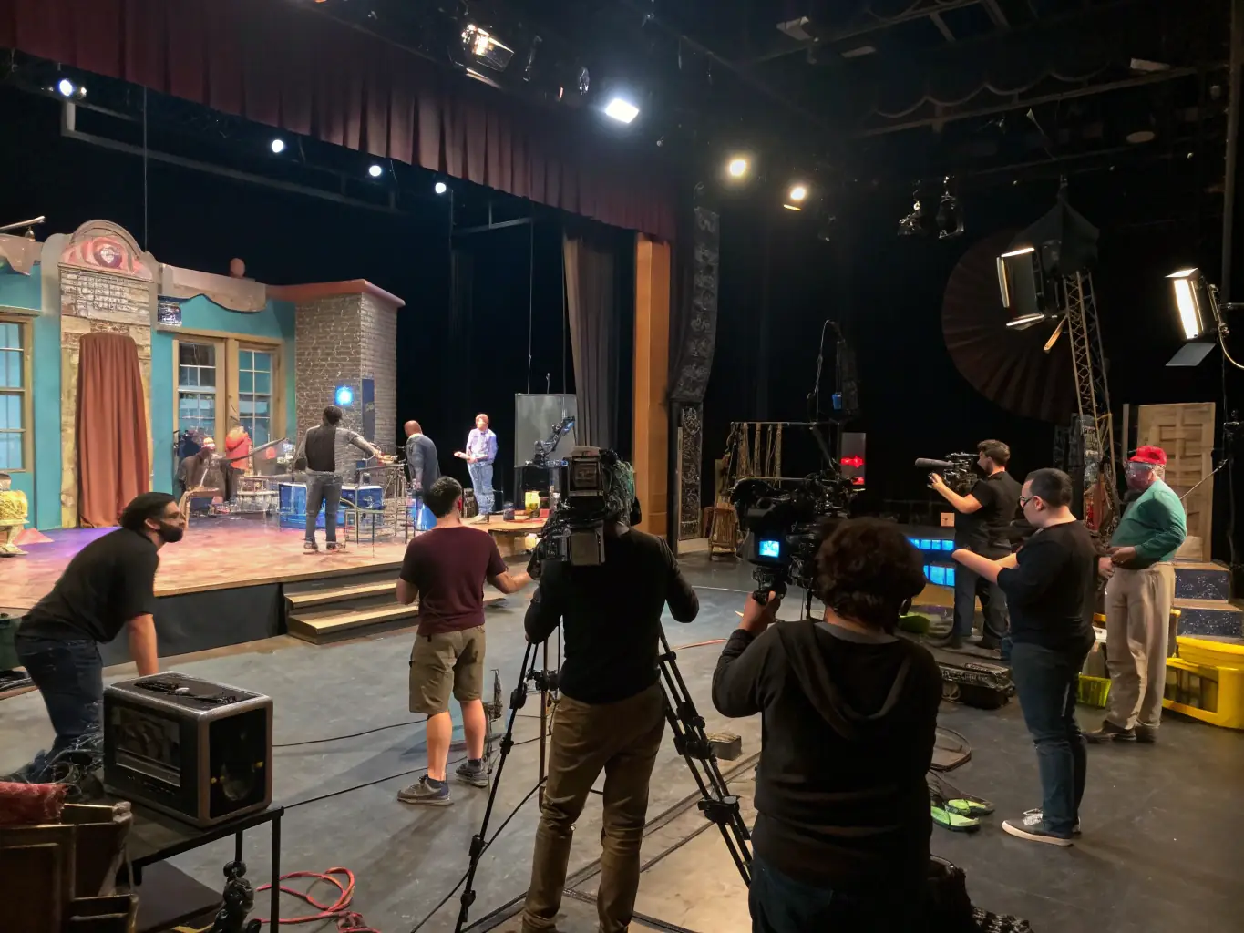 A behind-the-scenes shot of a technical rehearsal for a dance performance supported by Entrechats 17, showing the collaborative effort of dancers, technicians, and production staff.